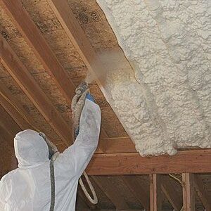 spray polyurethane foam insulation being applied on roof surface
