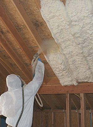 spray polyurethane foam insulation being applied on roof surface